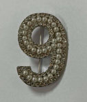 Nine brooch